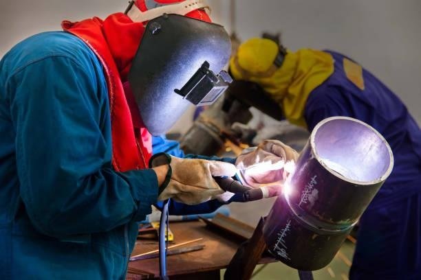 An expert welder welding the steel pipe with Tungsten Inert Gas Welding process (TIG)